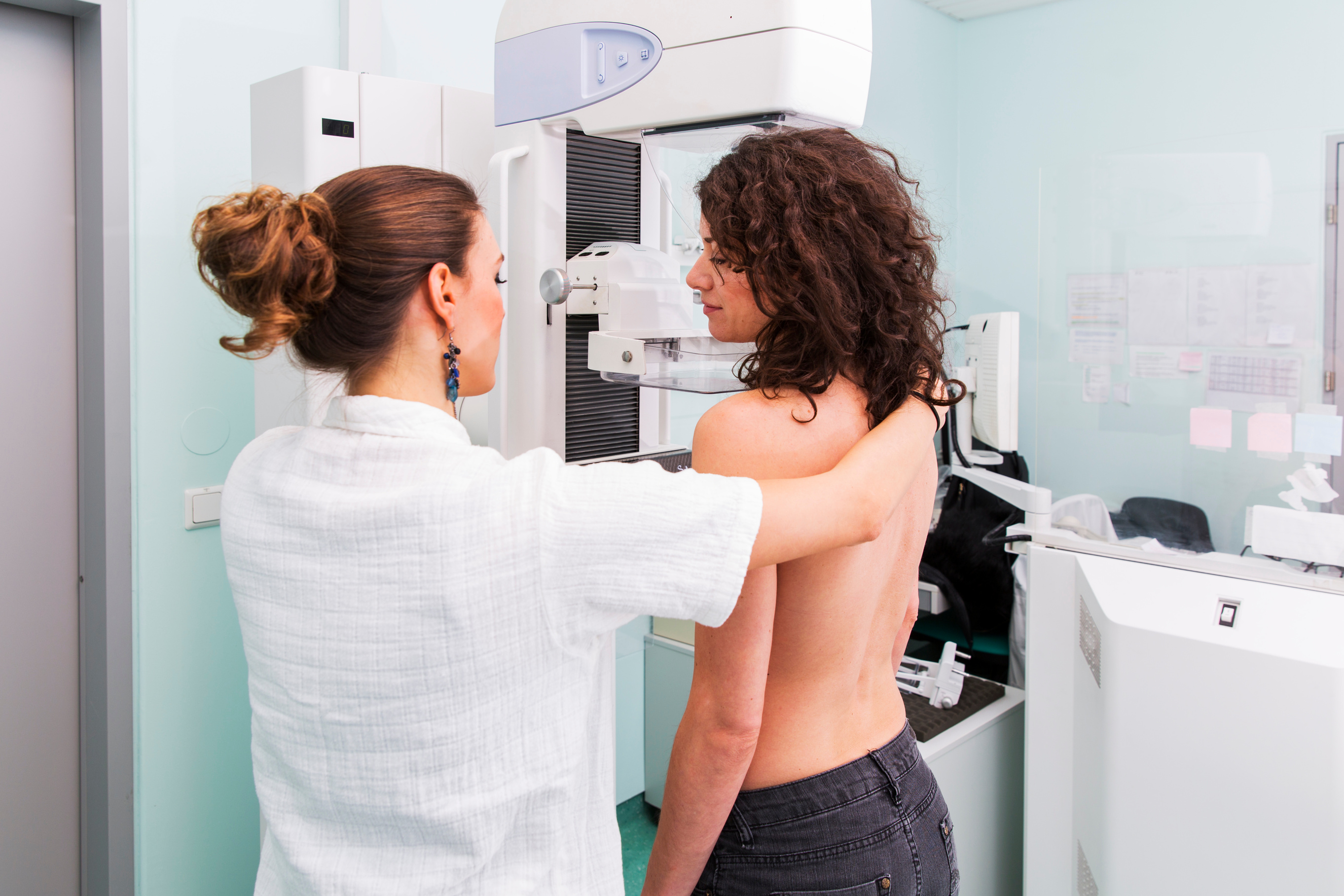 Nurse with young women having a mammography